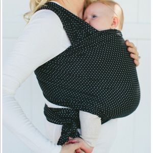 Solly Baby wrap. Black with white polka dots.